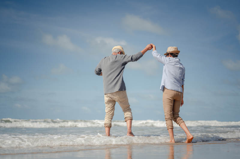 retired couple on beach